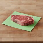 Green Steak Paper 12" x 9" shown with steak on sheet