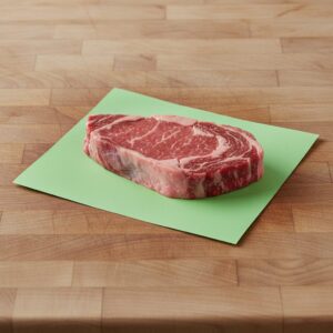 Green Steak Paper 12" x 9" shown with steak on sheet
