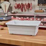 a white plastic lug in a butcher shop