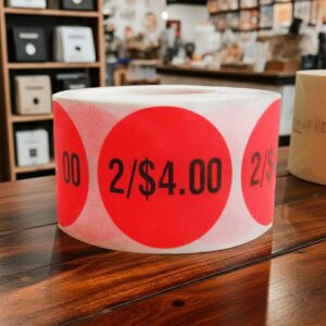 2 for 4 dollars round sticker with red background and black print
