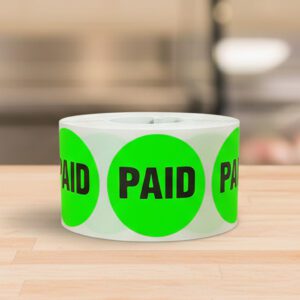 Paid sticker on a round green label with black print