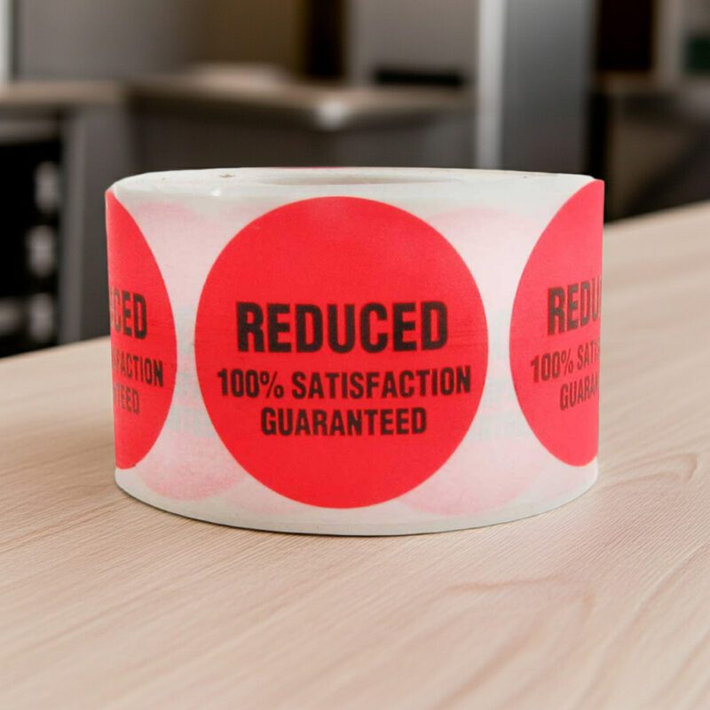reduced sticker on a round red label with black print with 100% satisfaction guaranteed