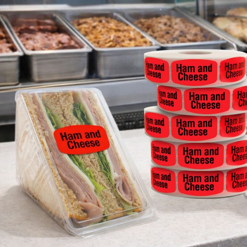 520031 Ham and Cheese Labels Ham and Cheese label with black text and bright red background on ham and cheese deli sandwich