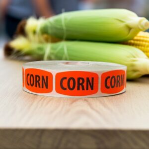 corn red sticker on a roll of labels