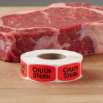 chuck steak stickers on a roll of red labels with black print