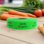 100% organic green sticker on a roll of labels