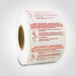 Safe Handling Label with red text on roll of stickers