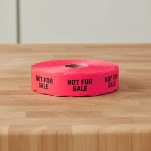 not for sale stickers on a roll of red labels with black print