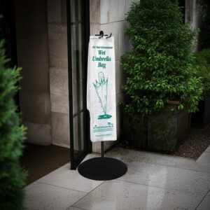 Biodegradable wet umbrella bag on a rack outside a hotel lobby