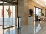 Single wet umbrella dispenser in lobby stainless steel