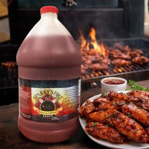 Sparky's Fire Sauce Gallon next to plate of bbq wings