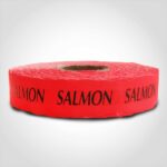 salmon label with red background on roll of stickers