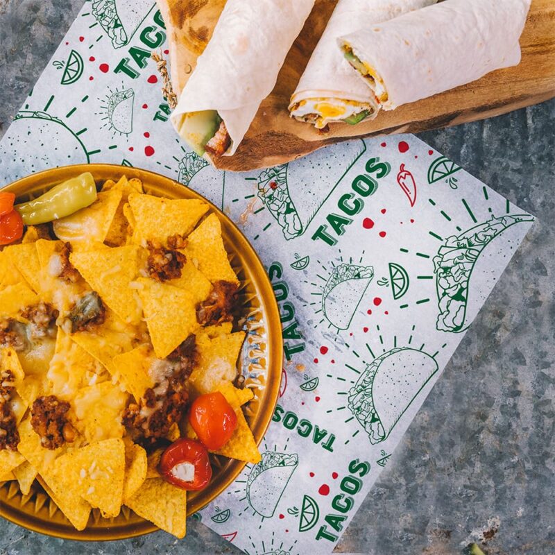 100076 Taco Paper Wrap SQ Taco Paper Wrap with tacos and nachos sitting on liner