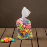 small popcorn bag with colorful popcorn inside on a table