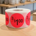 3 for 1 dollar round sticker on a red label with black text