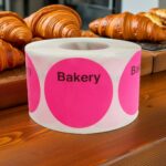 pink round sticker label with bakery printed on the top and room to write below it