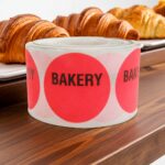 red round bakery sticker with the word bakery printed in black at the top