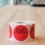 Deli circle sticker with room to write on a red label with black print