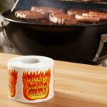 Great On The Grill Flames Label Stickers roll of labels next to grill