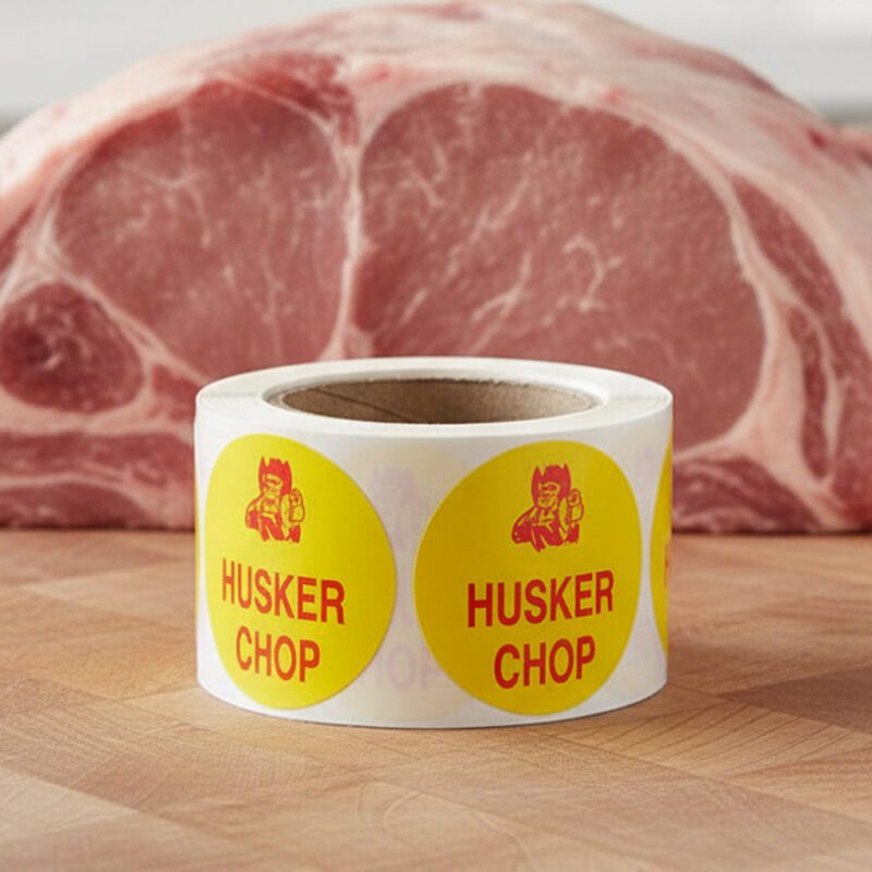 Husker chop sticker on a yellow label with cartoon image of husker