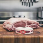 fresh pork bilingual spanish and english strap label on butcher block