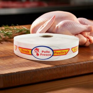 fresh poultry bilingual spanish and english strap label on roll of sticker on butcher block