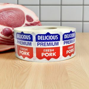 fresh pork sticker on a white ribbon label with red and blue text and reads delicious premium