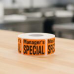 manager's special sticker on an orange label with black print
