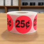 25 cents round sticker on a roll of red labels with black print