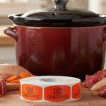 fine for crockpot sticker on a red label with black print