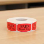 paid thank you sticker on a red label with black text