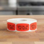 special of the week sticker on a red label with black text