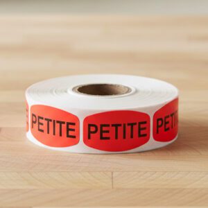 petite sticker on a red label with black text