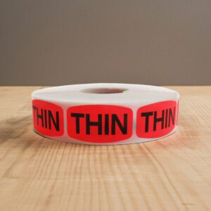 Thin sticker on a red label with black print
