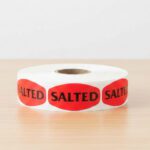salted sticker on a red label with black text