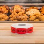 chicken sticker on a red label with black print