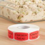 chicken salad sticker on a red label with black print