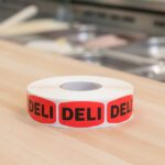 deli sticker on a red label with black print
