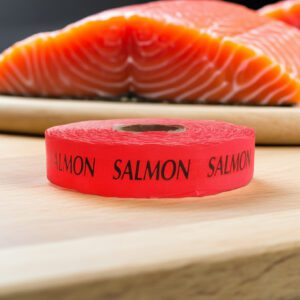 salmon sticker on a red label with black text