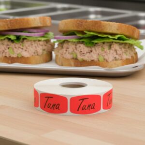 Tuna sticker red identification label with black print on a roll of stickers