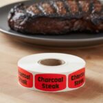 charcoal steak sticker on a red label with black print