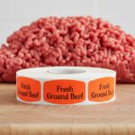 fresh ground beef sticker on a red label with black print