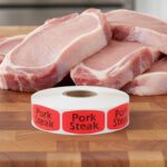 pork steak sticker on a red label with black text