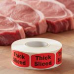 thick sliced sticker on a red label with black text