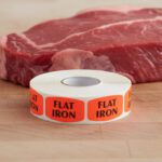 flat iron sticker on a red label with black print