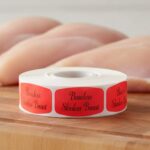 boneless skinless breast sticker on a red label with black print