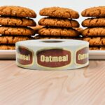 oatmeal label on a gold foil sticker with oatmeal cookies behind it