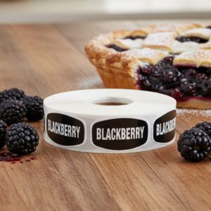 blackberry sticker with black background and white text with blackberry pie next to the roll of labels