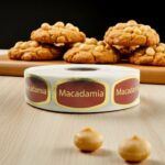 macadamia sticker on a gold foil label in front of macadamia cookies