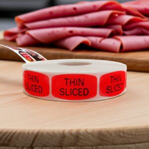 Thin Sliced sticker red identification label with black print on a roll of stickers